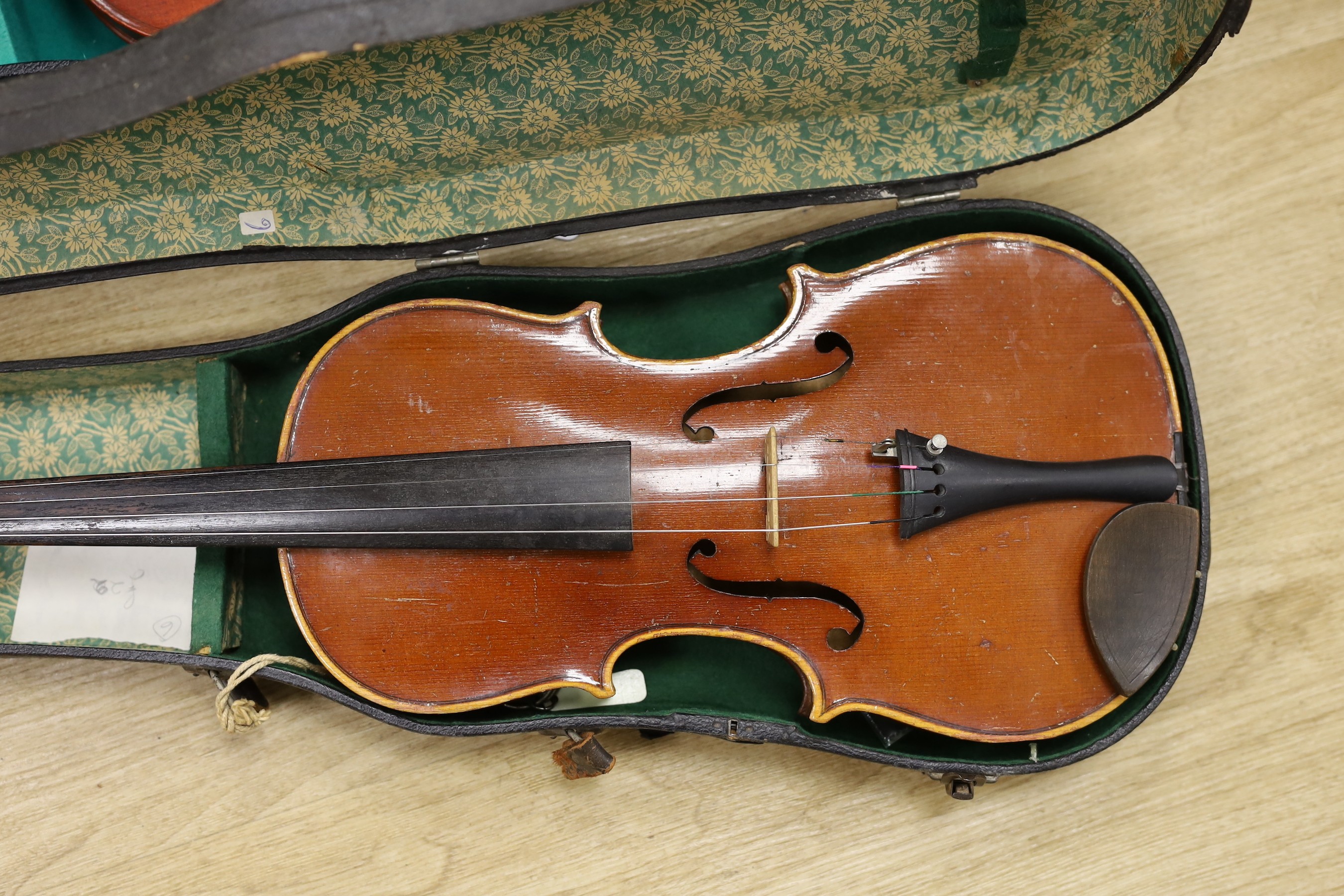 Two cased violins, one bow